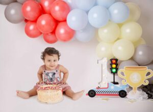 Baby celebrating first birthday with cake