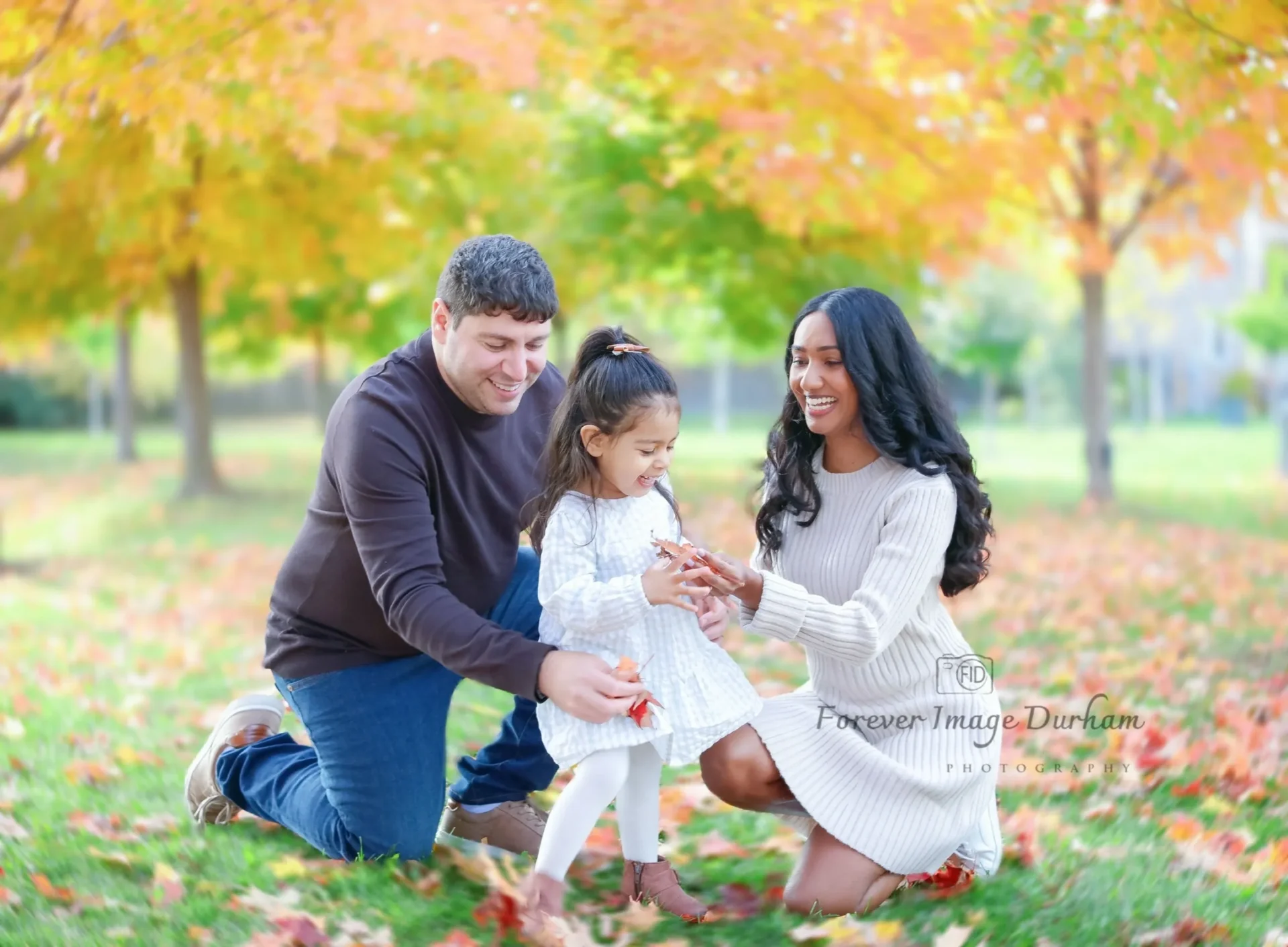 Family enjoying autumn park together