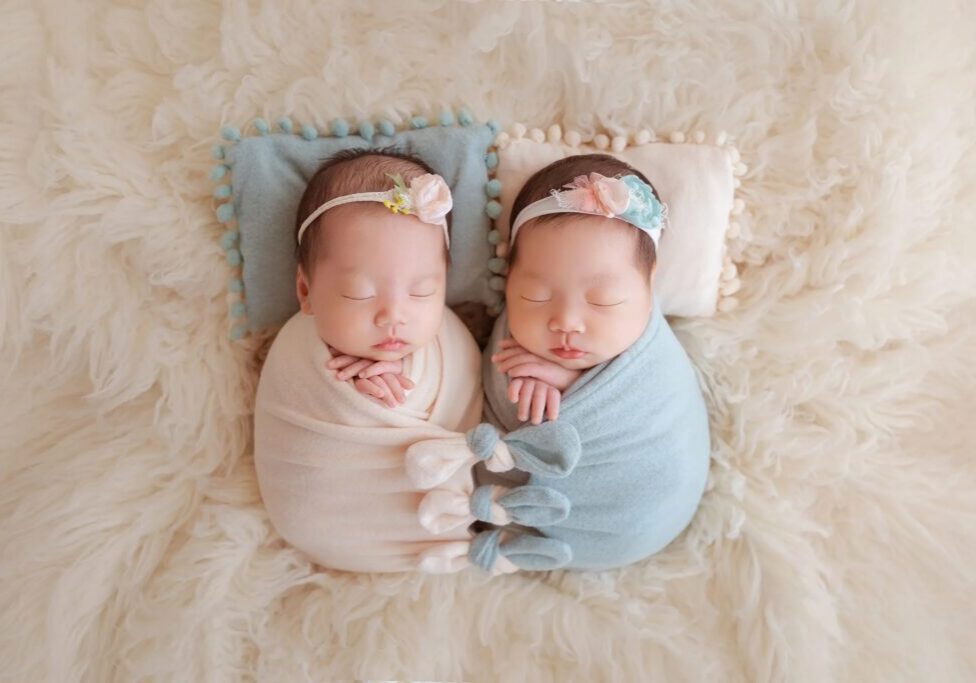 Twin babies sleeping in soft wraps