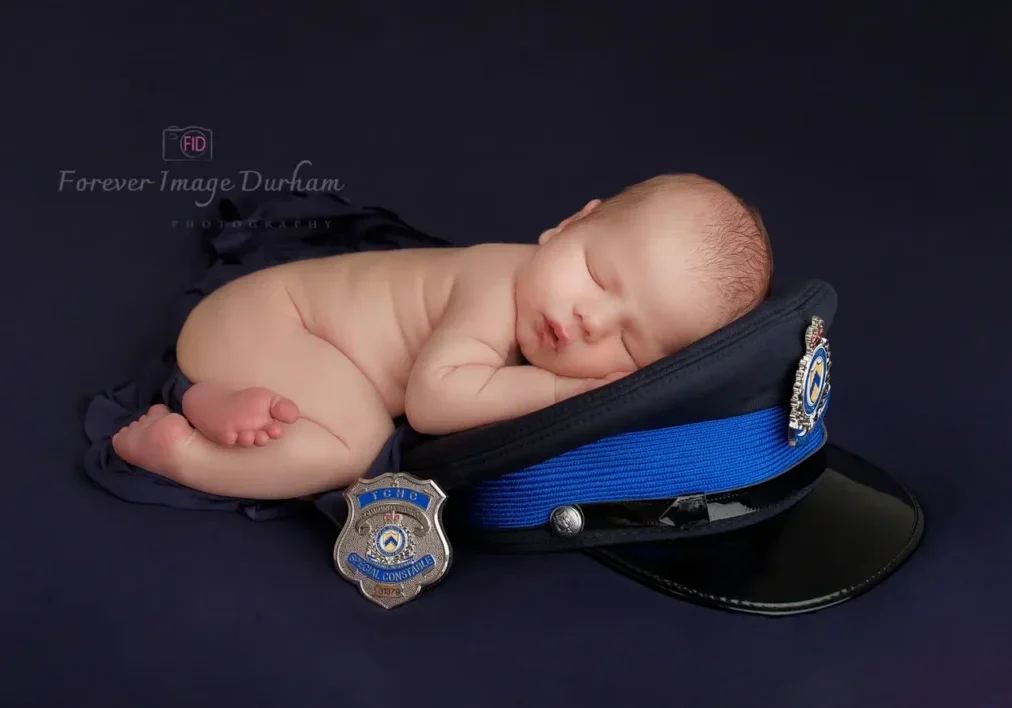 Peaceful infant beside police badge
