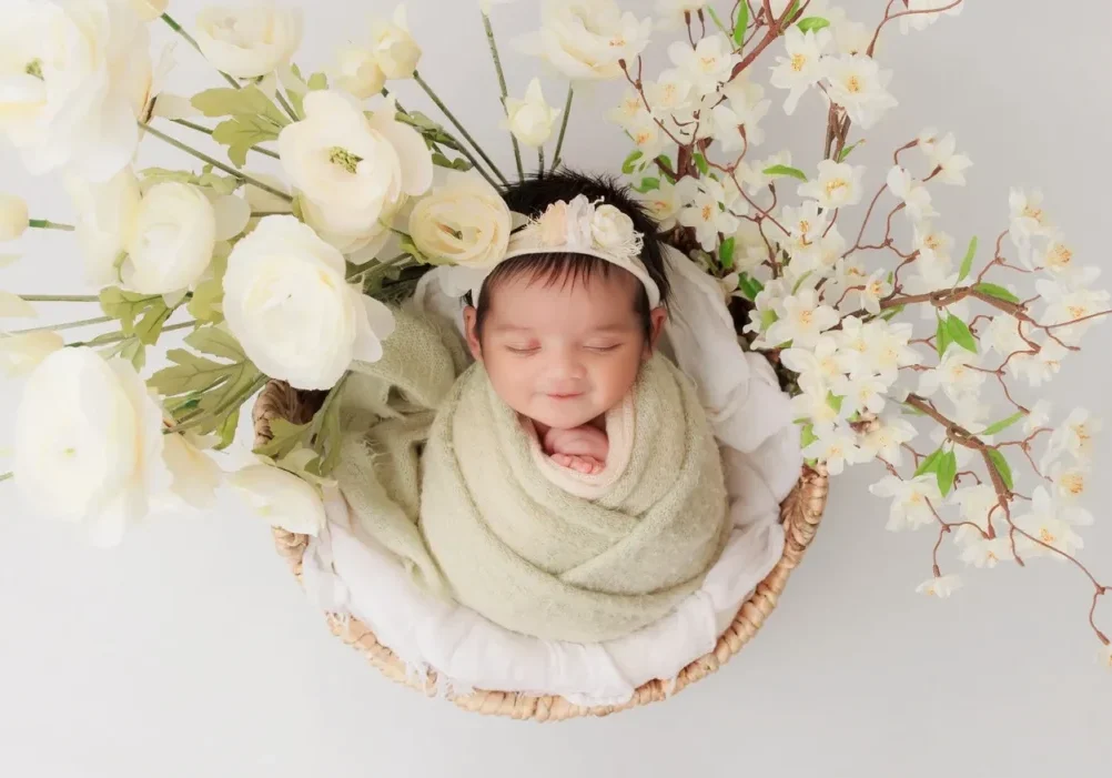 Newborn wrapped in green blanket