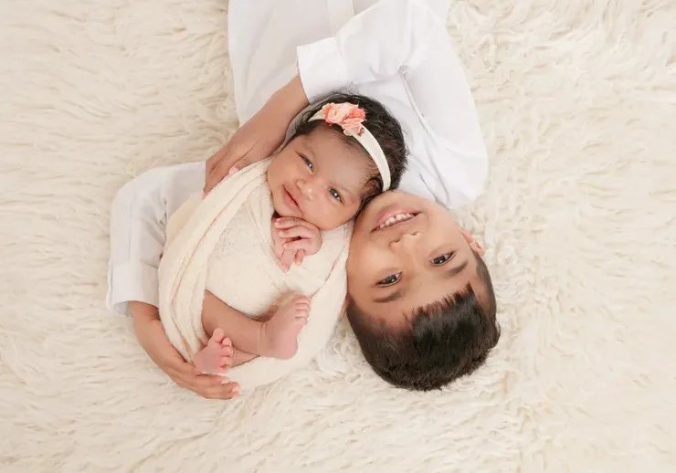 Happy children lying on soft surface